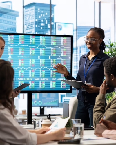 profitability-employees-gather-around-screen-to-discuss.jpg